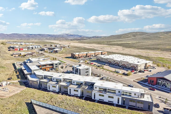 Modern multi-story buildings featuring varied facades and flat roofs