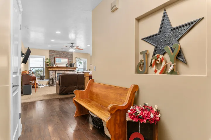 Hallway entryway featuring wood-finish flooring, a built-in wall niche, and an open concept layout