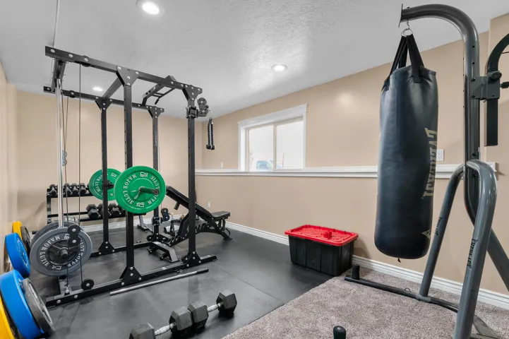 Dedicated fitness space featuring recessed lighting and durable flooring