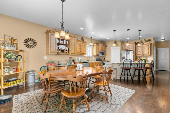 Open-concept kitchen and dining area featuring wood-finish flooring