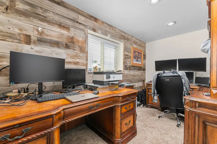 Room with wood-finish accent wall and recessed lighting