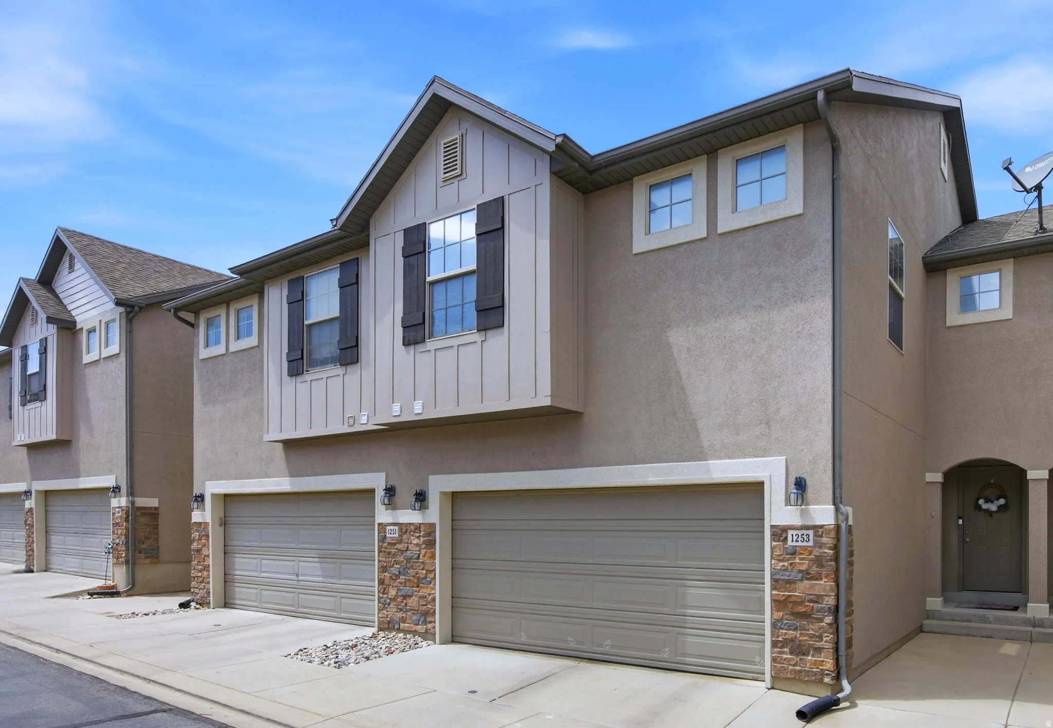 Stucco exterior with stone veneer accents and multi-pane windows