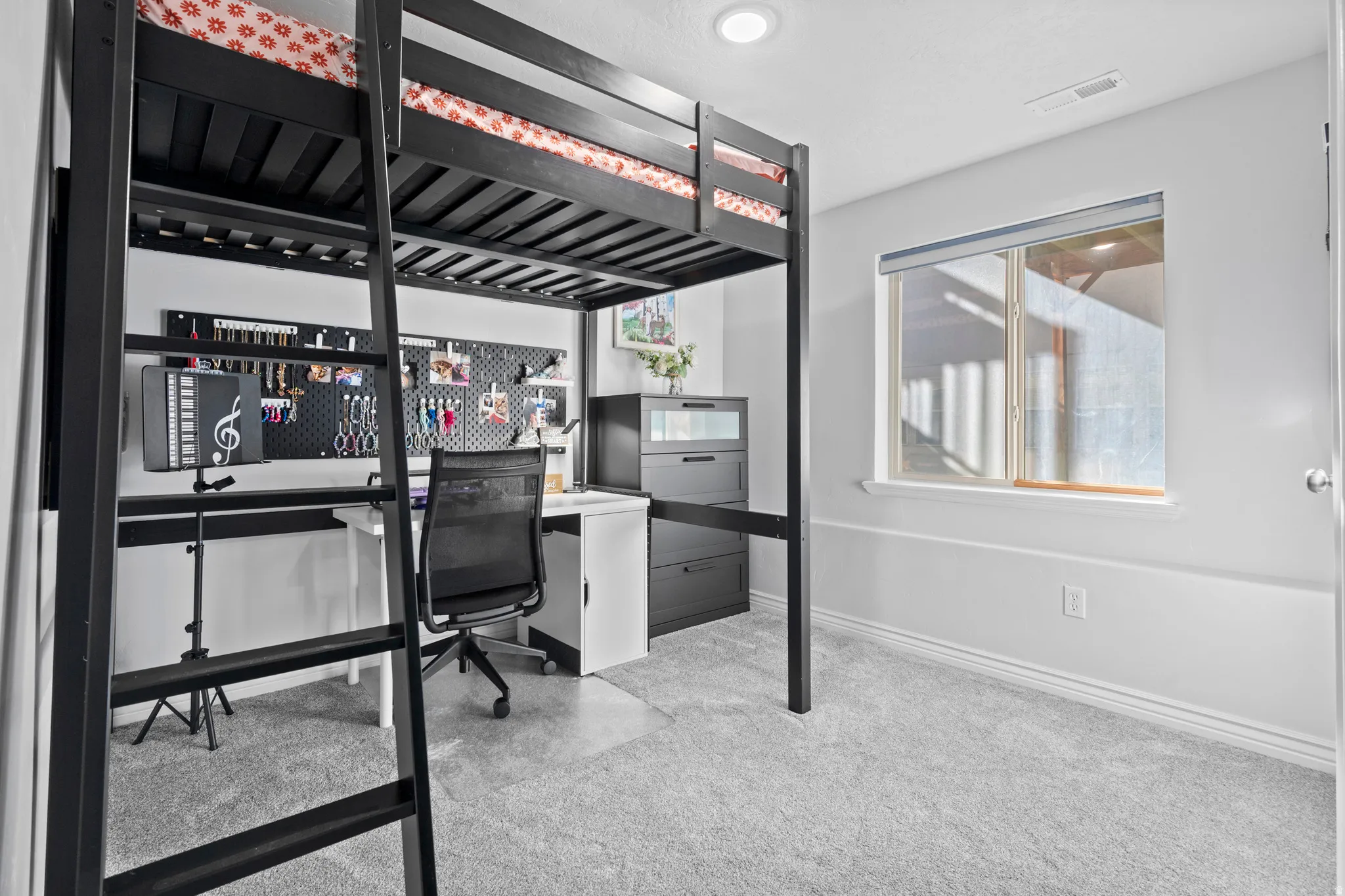 Room featuring a built-in loft bed with integrated desk space, light gray carpeting, neutral wall paint, a single window, and a recessed ceiling light