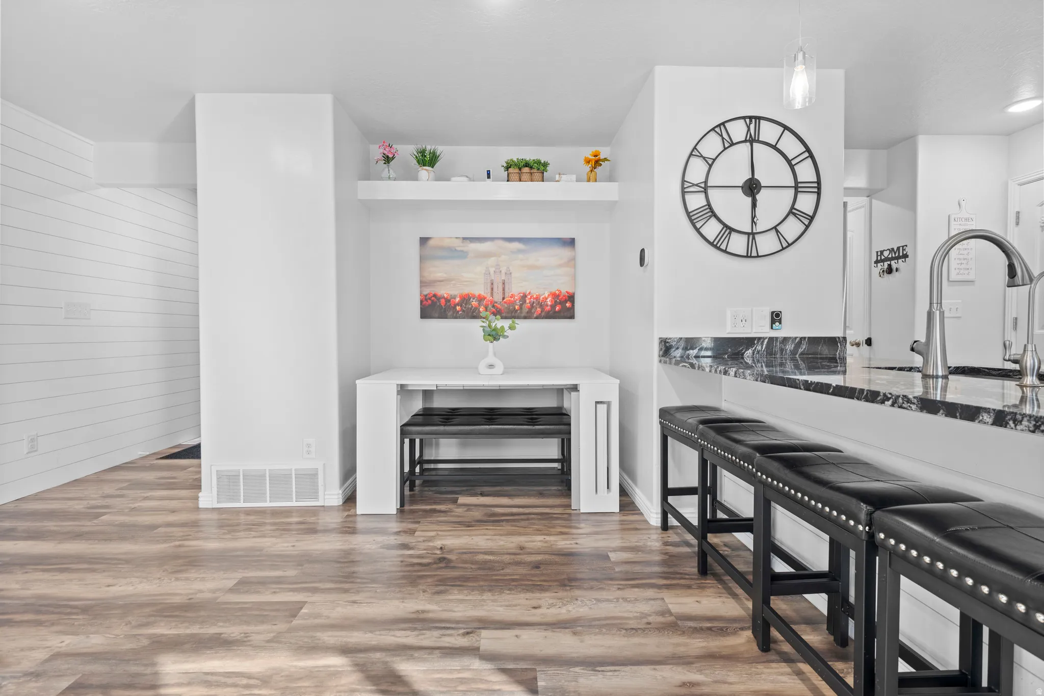Open-concept living space with wood-finish flooring