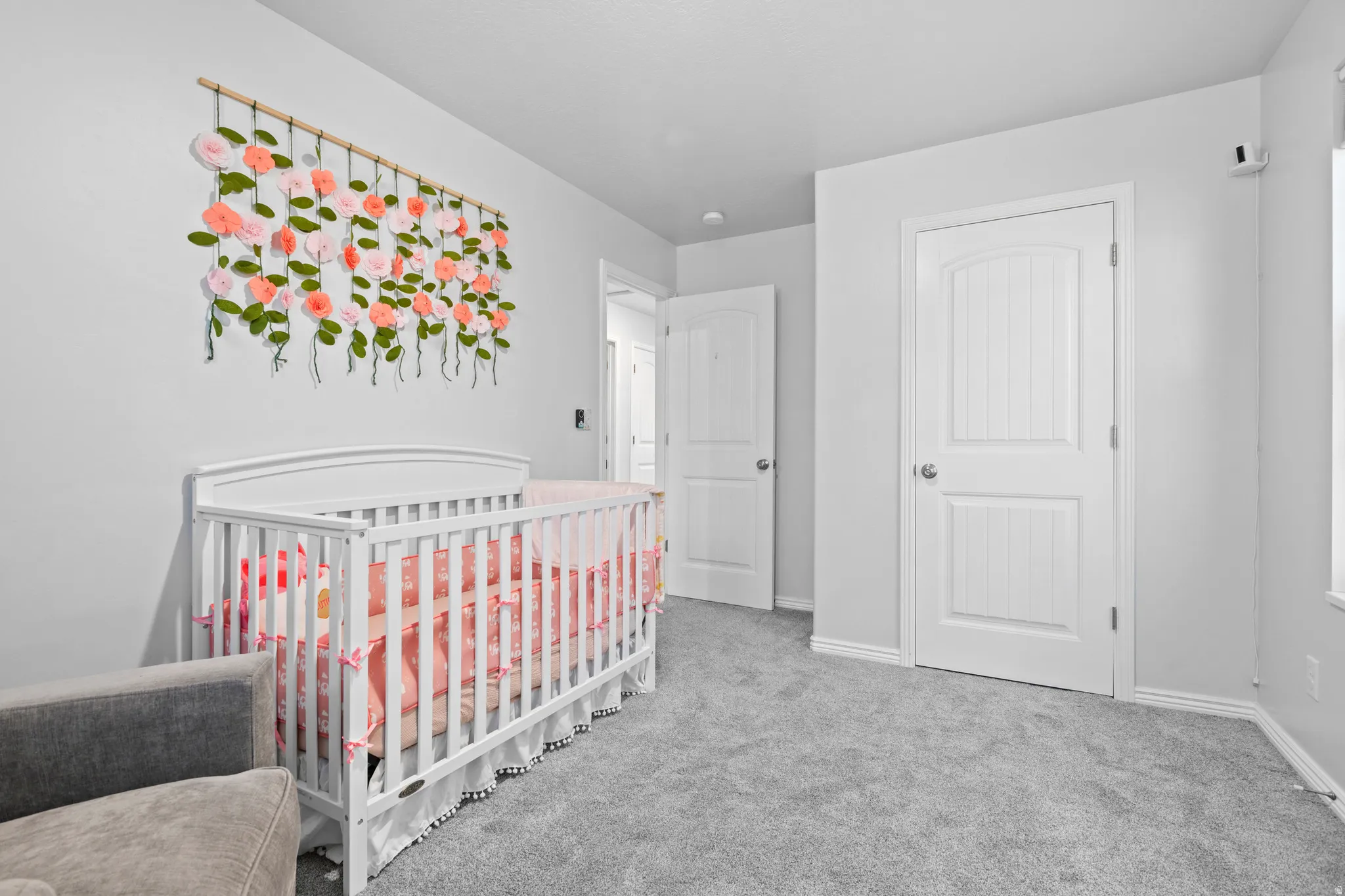 Carpeted room featuring white trim, light gray walls, and two paneled interior doors