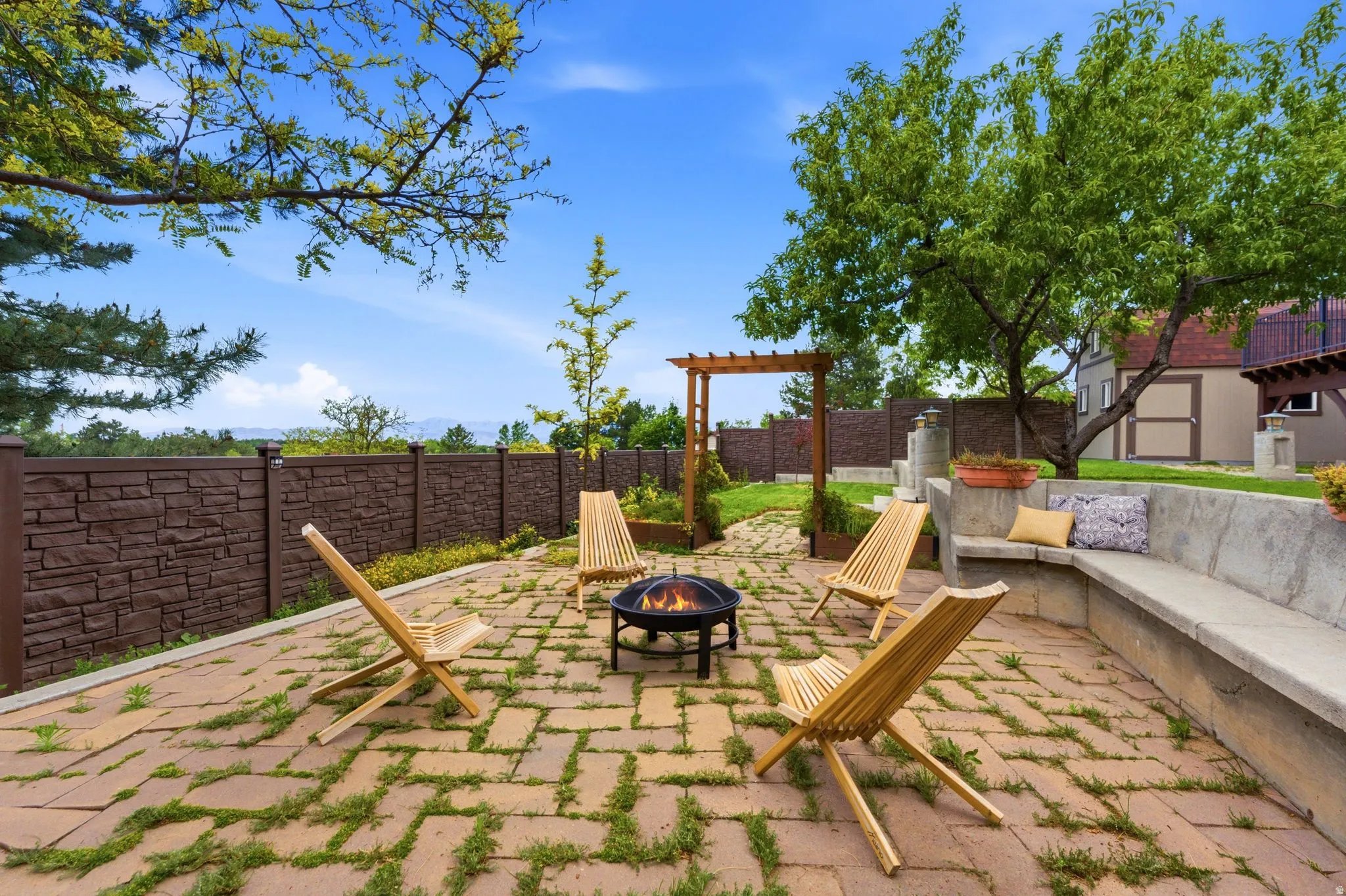 Brick paver patio featuring a central fire pit