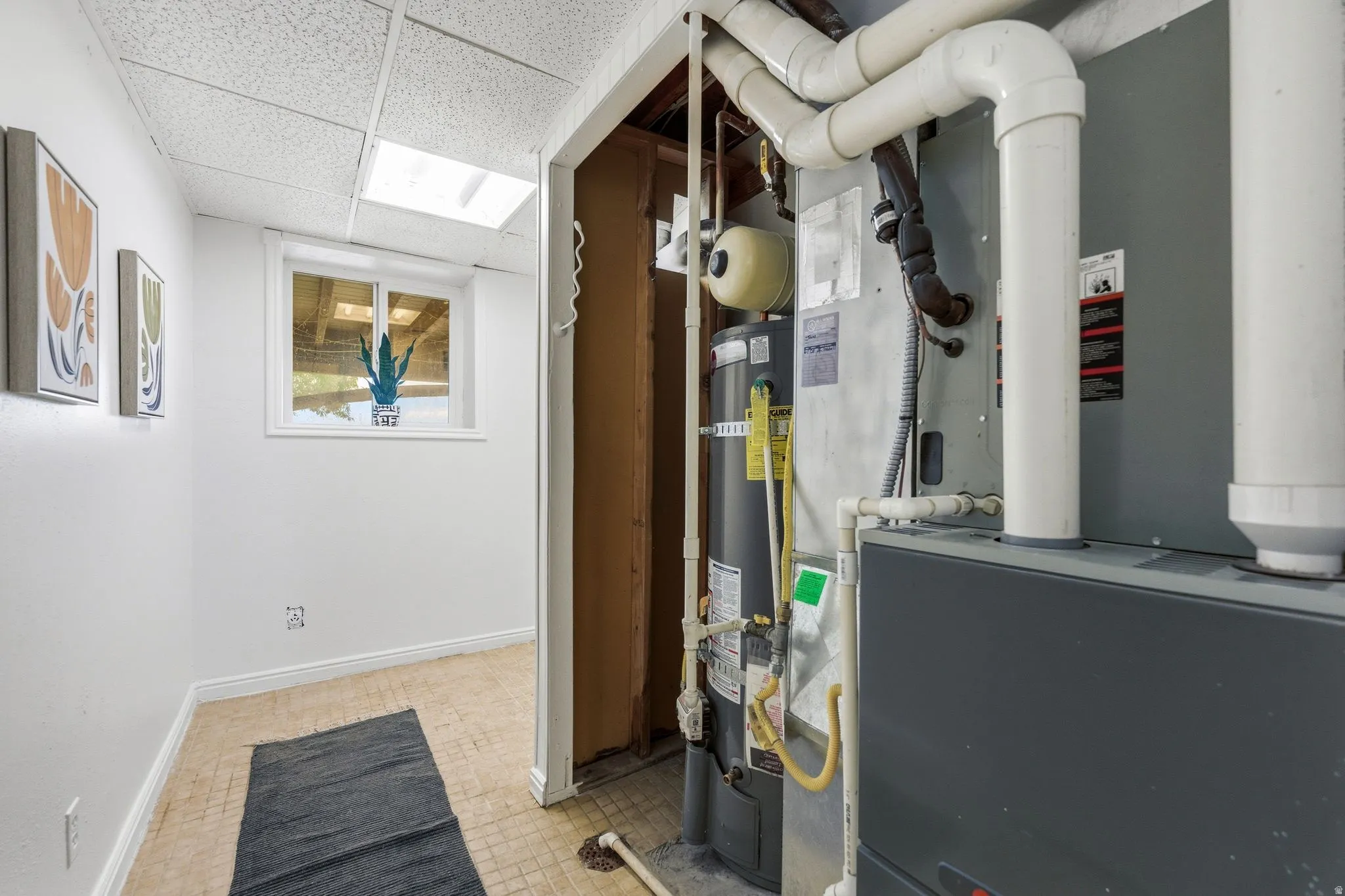 Utility area featuring a furnace and water heater installation