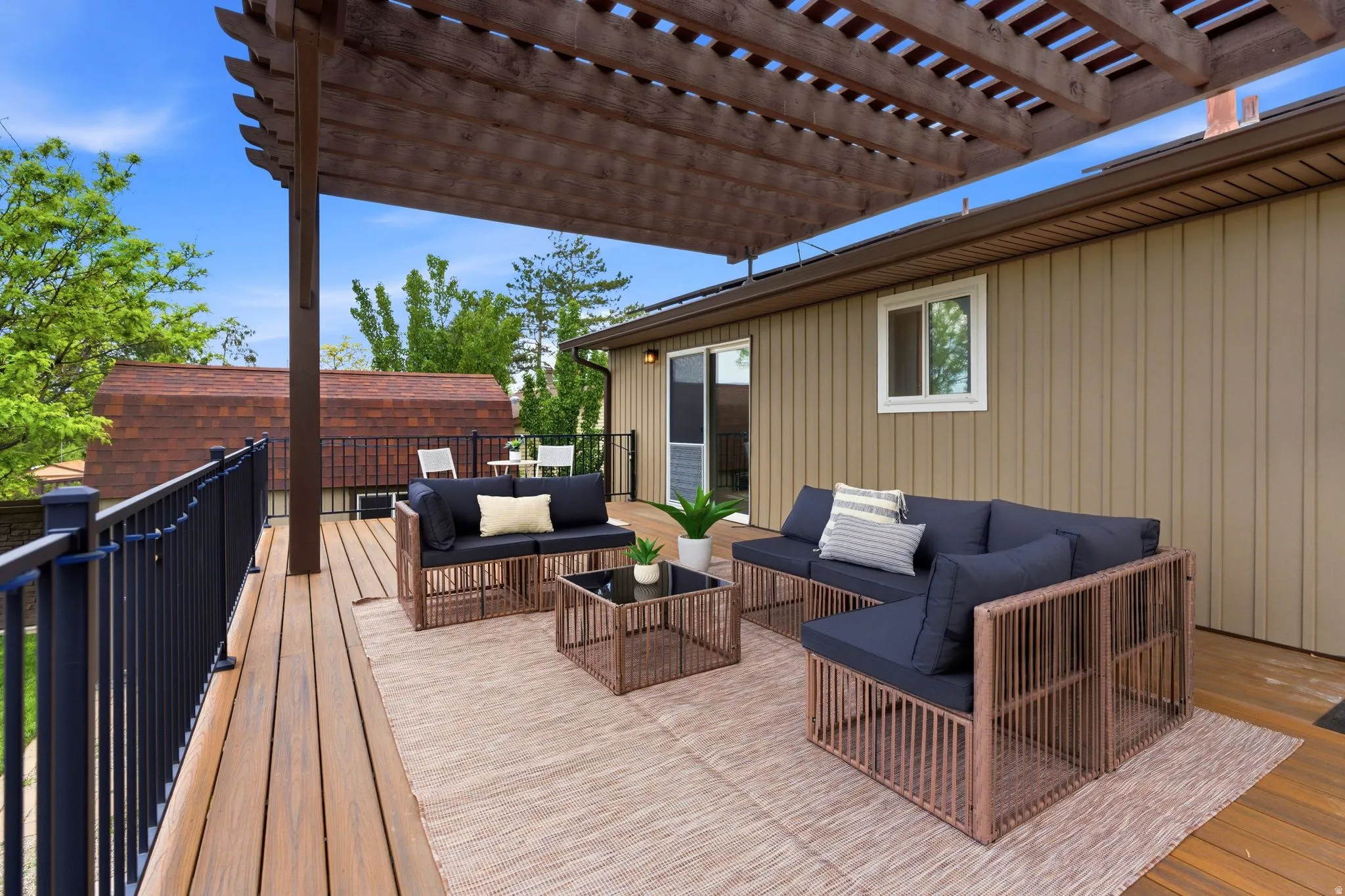 Expansive wood-finish deck with a large pergola