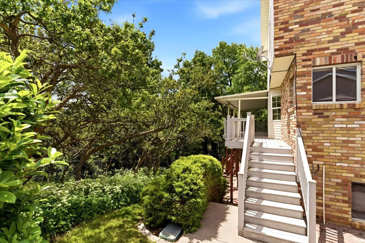 Outdoor deck with white railings and steps
