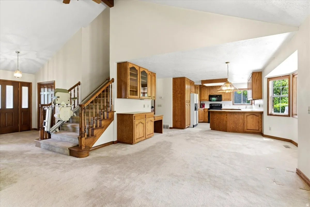 Spacious interior featuring vaulted ceilings and an open-concept kitchen