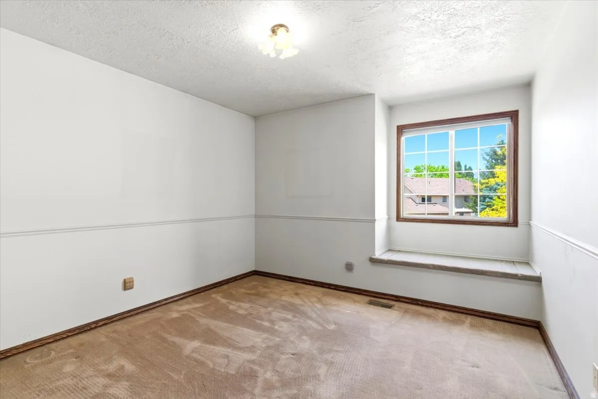 Recessed window with brown wood-trim framing and a built-in window seat