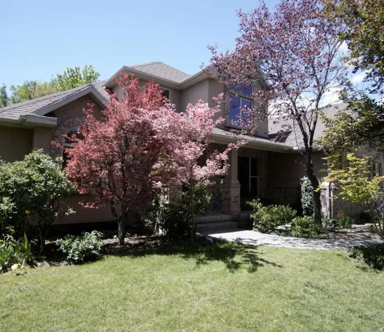 Stucco exterior with stone accent columns and arched window detailing