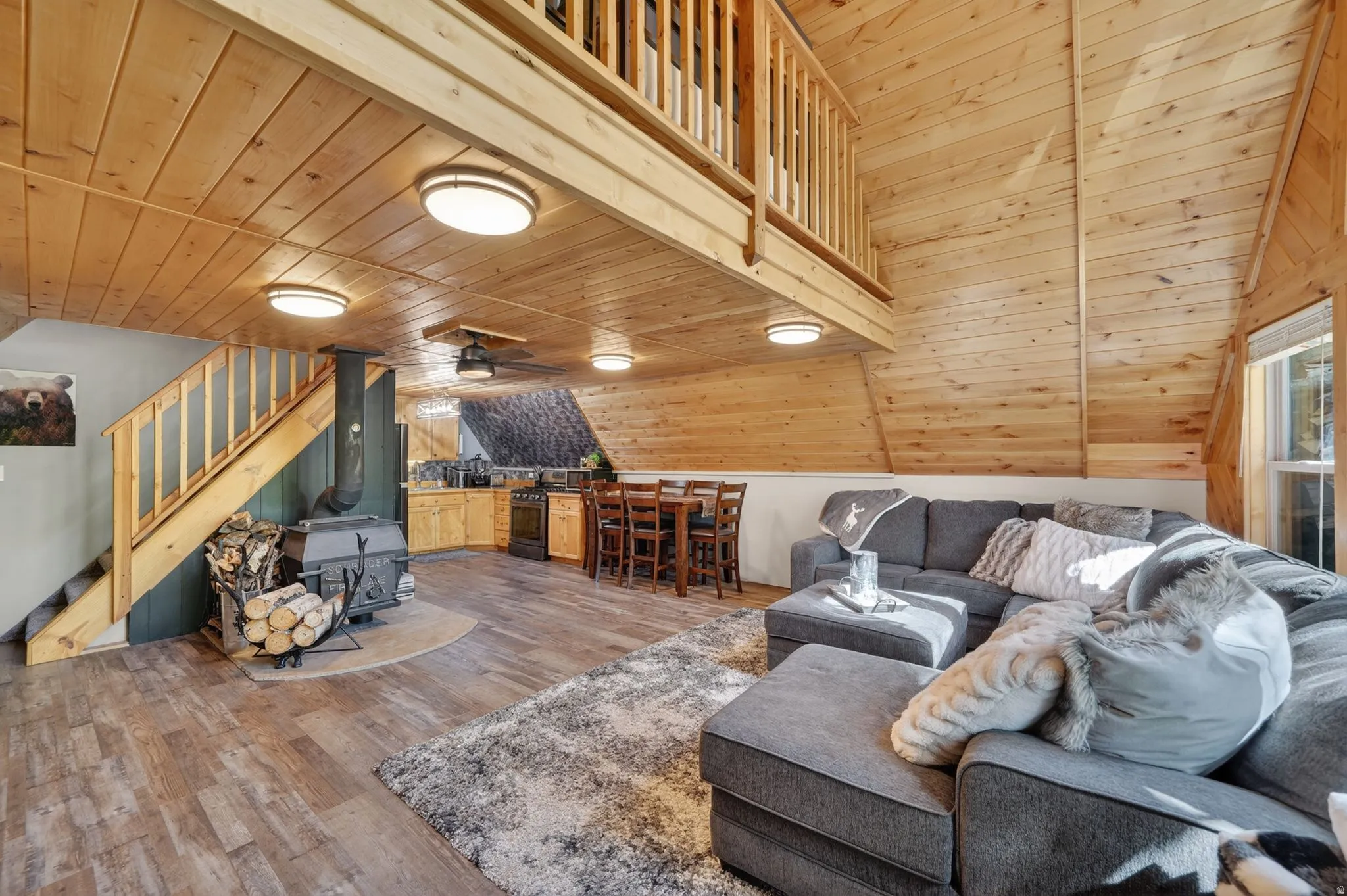Open concept interior featuring natural wood-finish walls and ceilings