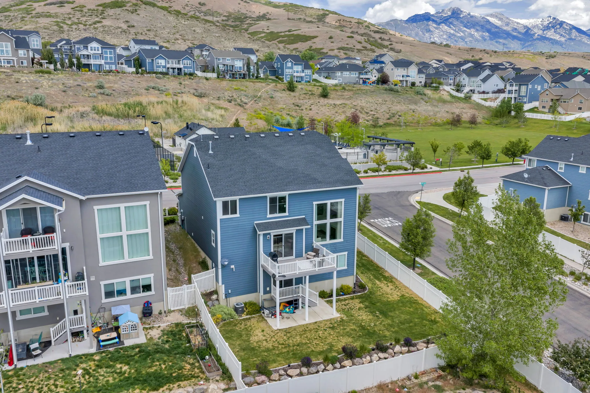 Two-story exterior with blue siding and a dark gray roof