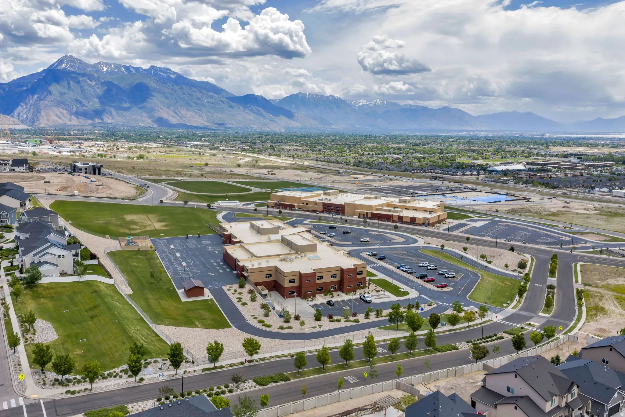 Contemporary community featuring multiple institutional buildings, paved parking areas, and manicured green spaces