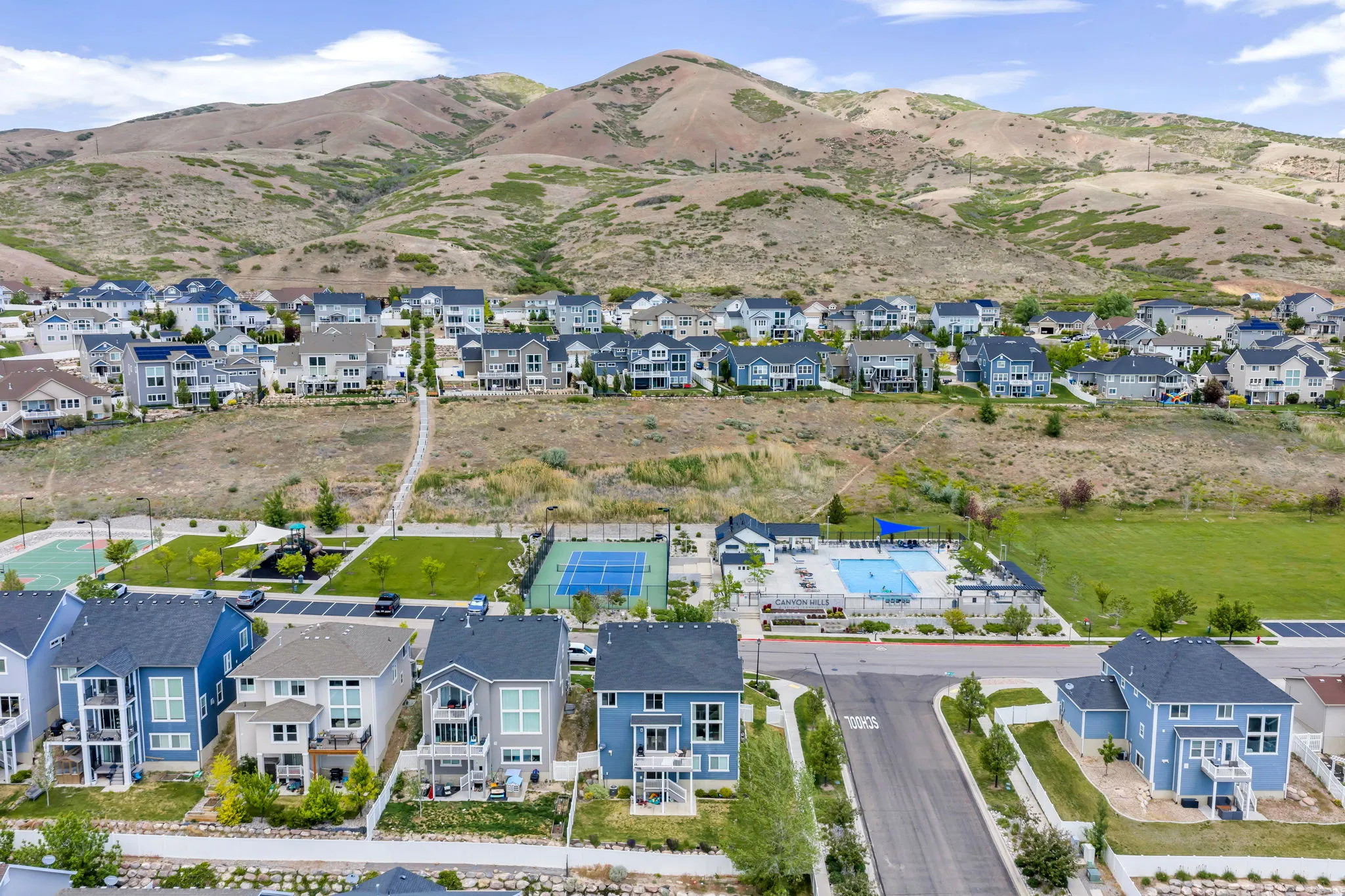 Modern residential development featuring hillside homes with varied architectural styles