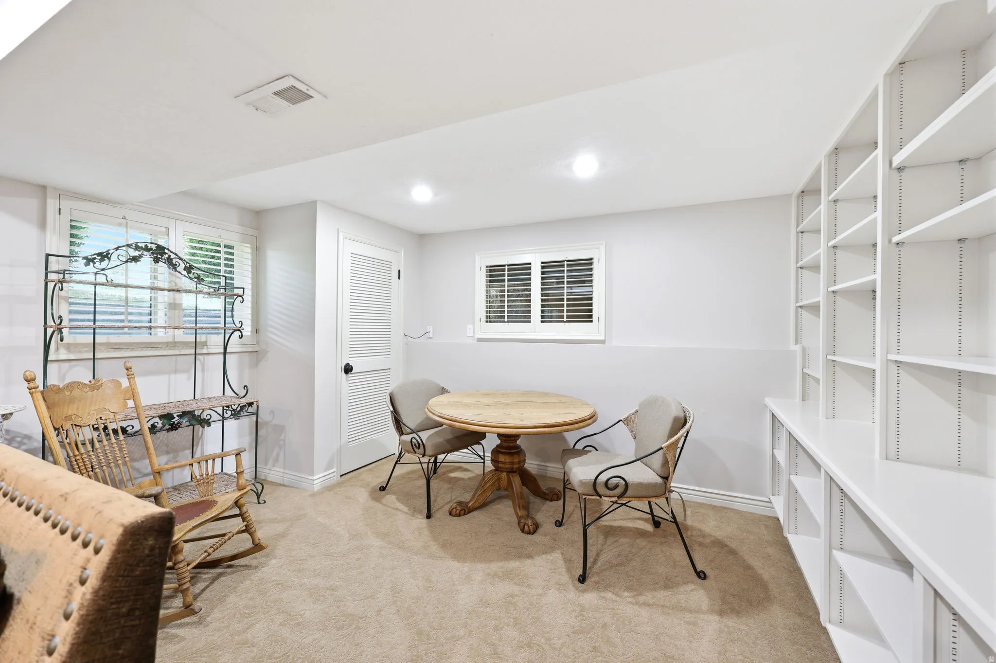 Built-in shelving and ample natural light define this versatile room