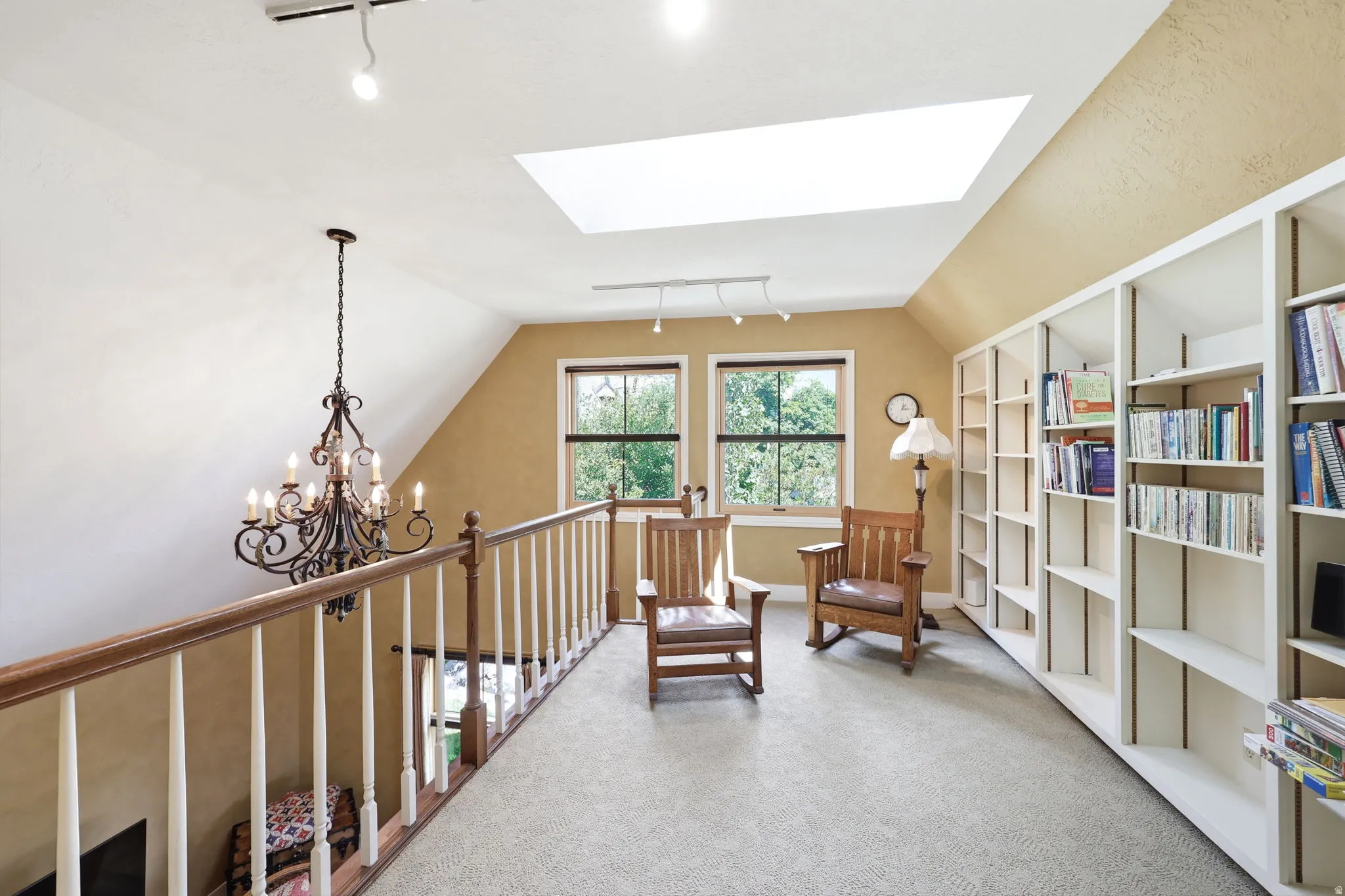 Upper-level landing featuring a large skylight, recessed lighting, and wall-to-wall carpeting