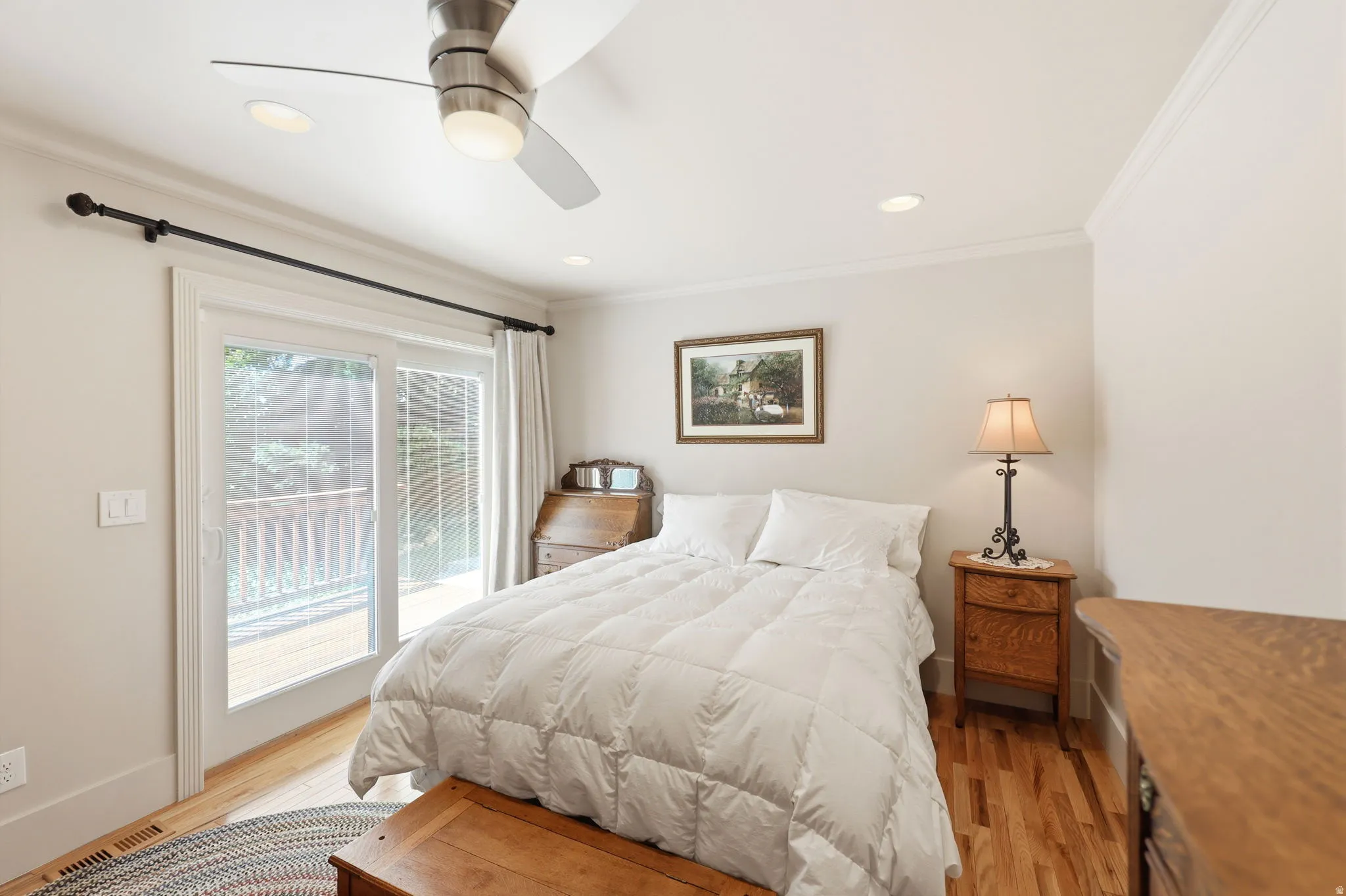 Hardwood flooring complemented by a sliding glass door opening to an exterior deck