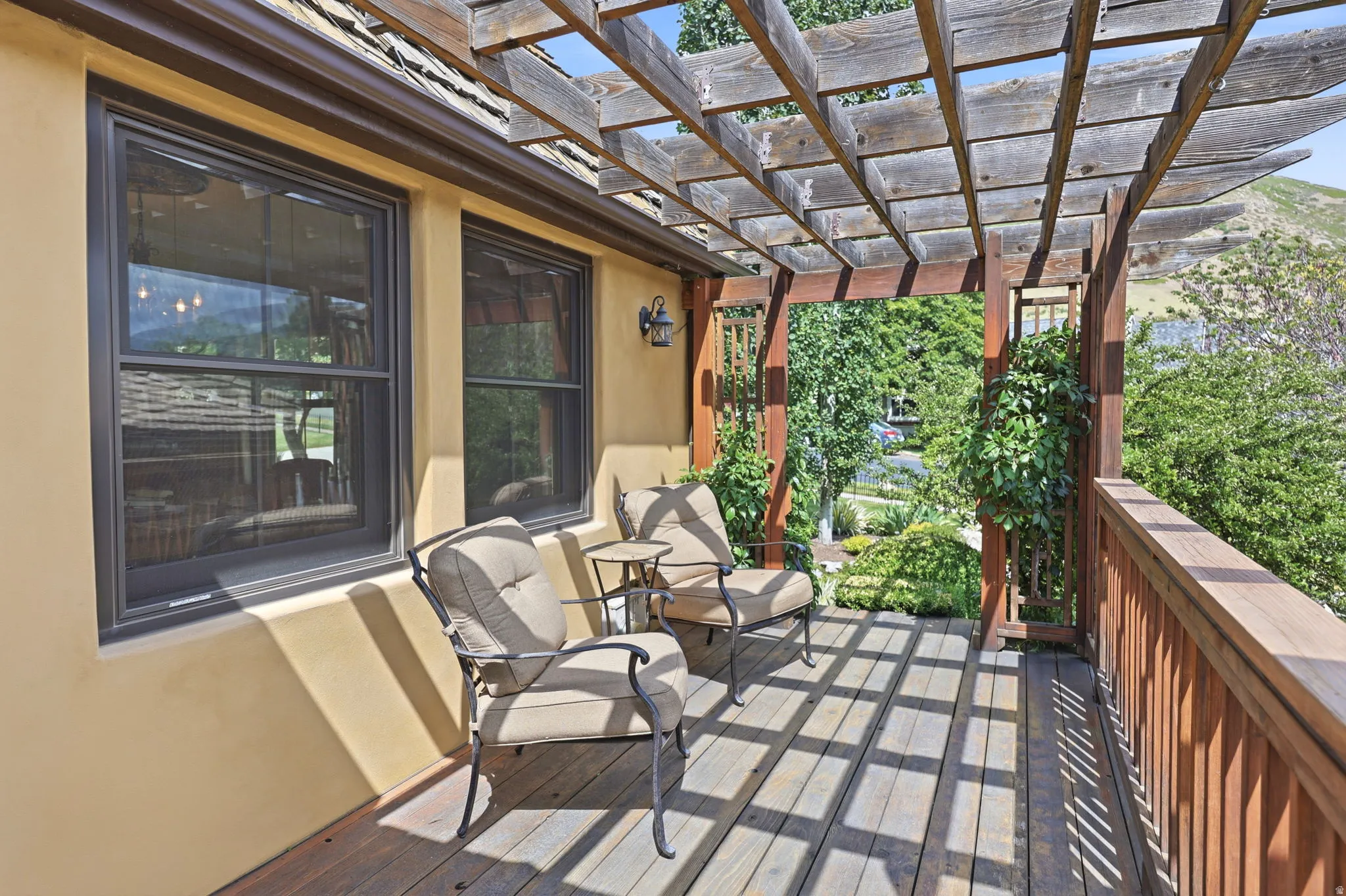 Expansive wood deck with a slatted pergola overhead