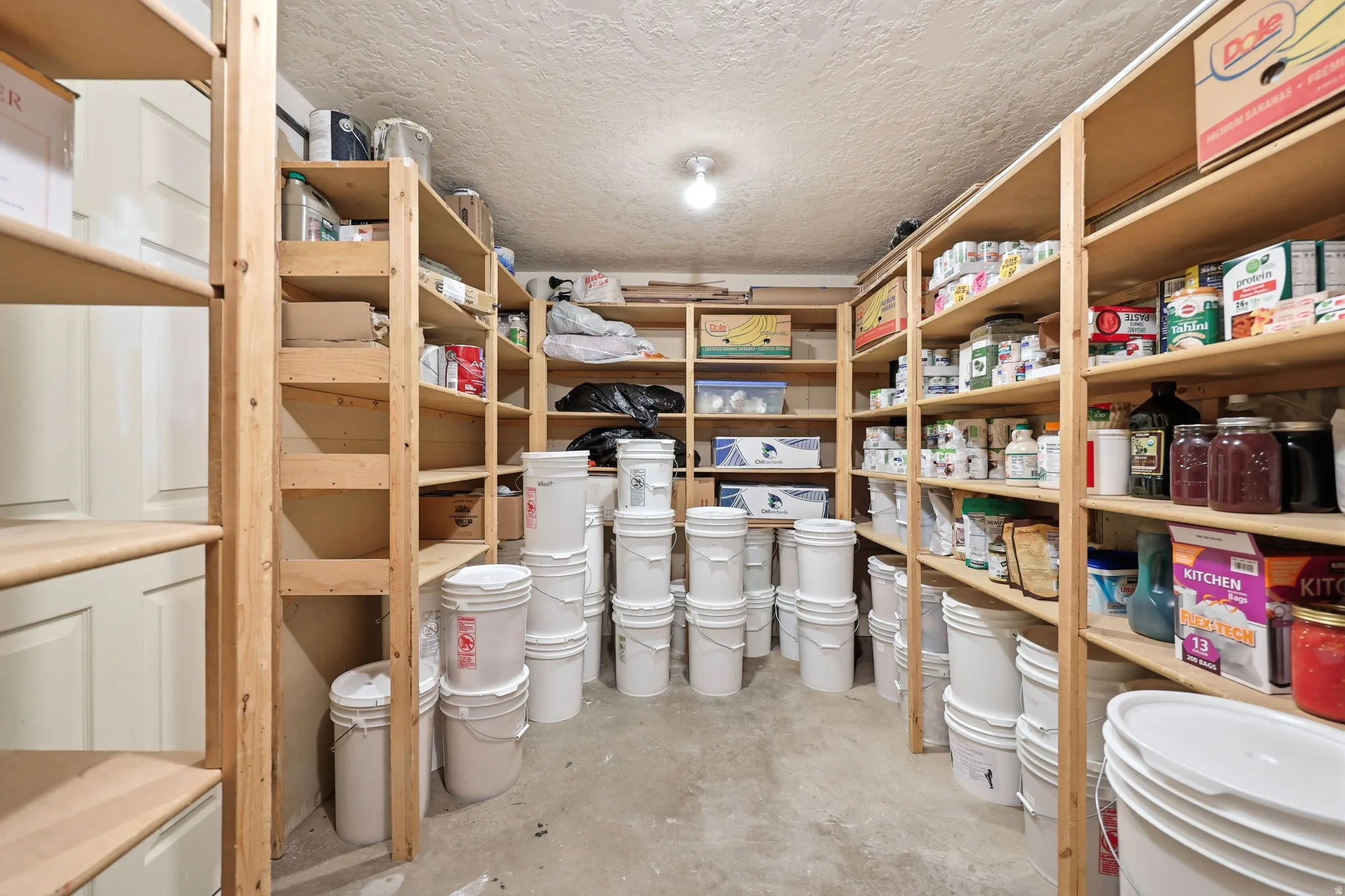 Dedicated storage room featuring extensive wood shelving