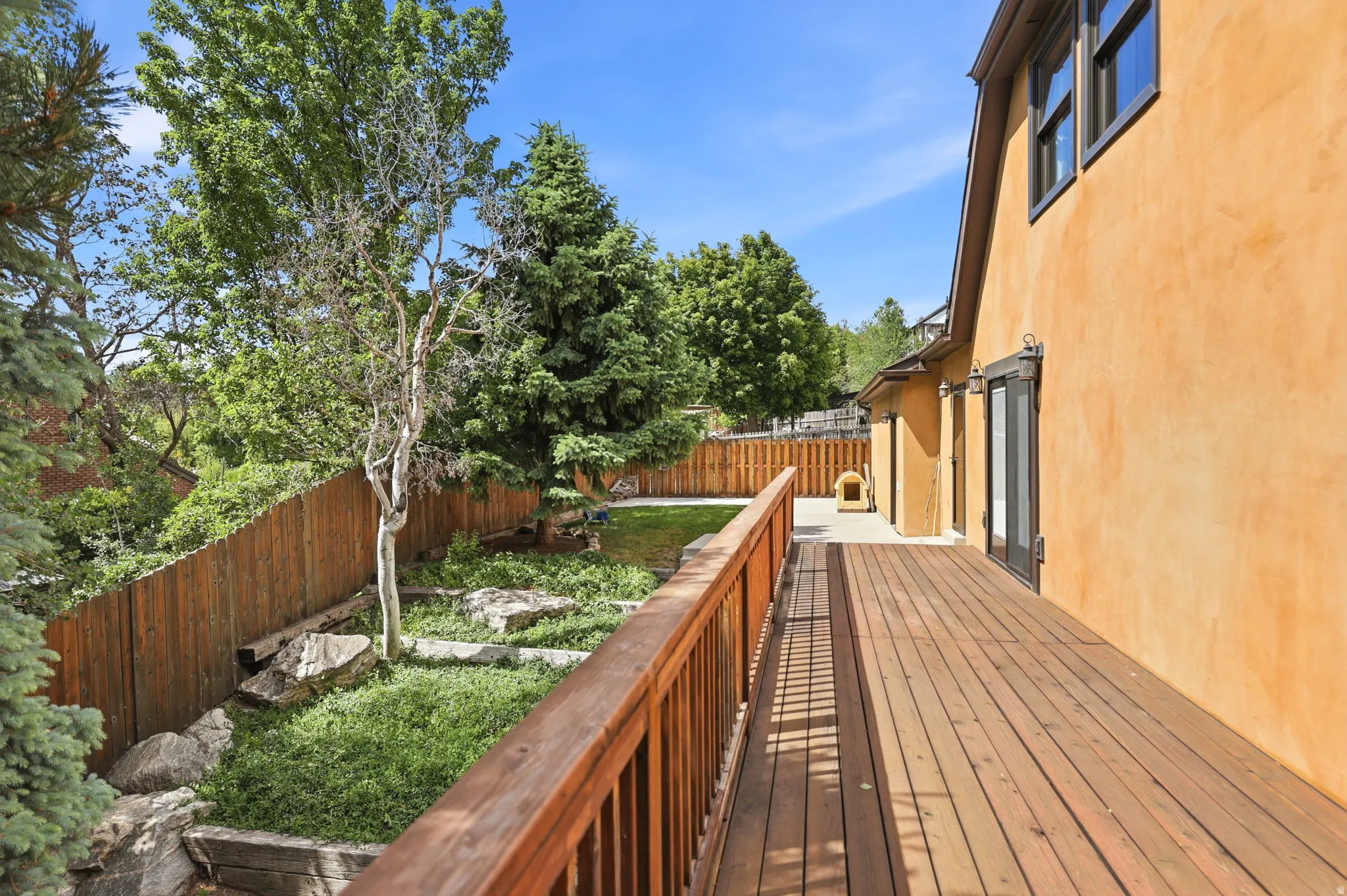 Spacious outdoor deck featuring wood-finish decking and railing