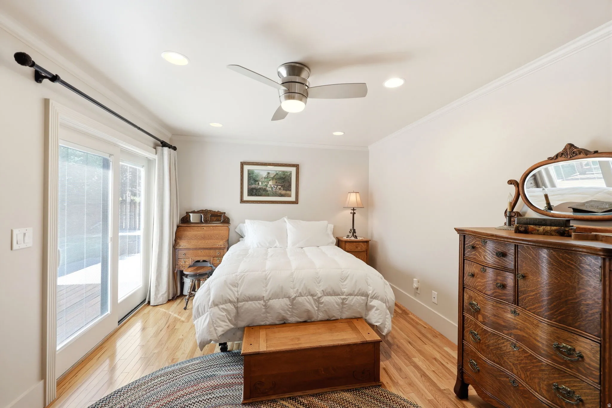 Room with wood-finish flooring, recessed lighting, and crown molding