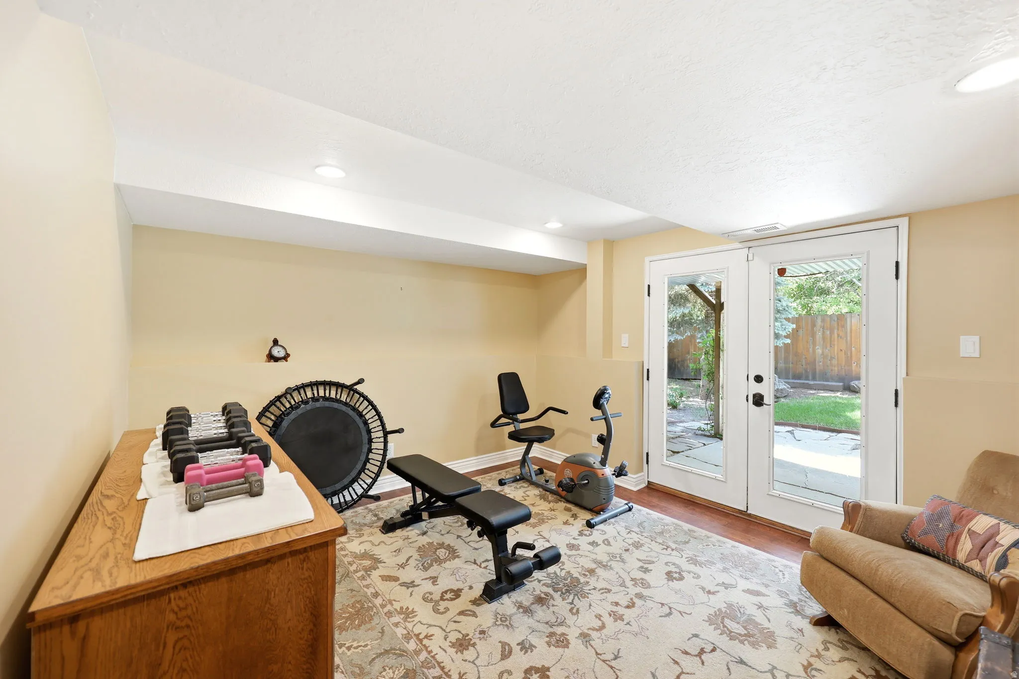 Bright room featuring white French doors with integrated glass panels, recessed ceiling lighting, and light-toned walls