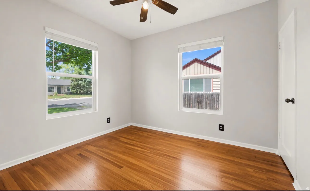 Hardwood flooring throughout, with two windows providing natural light