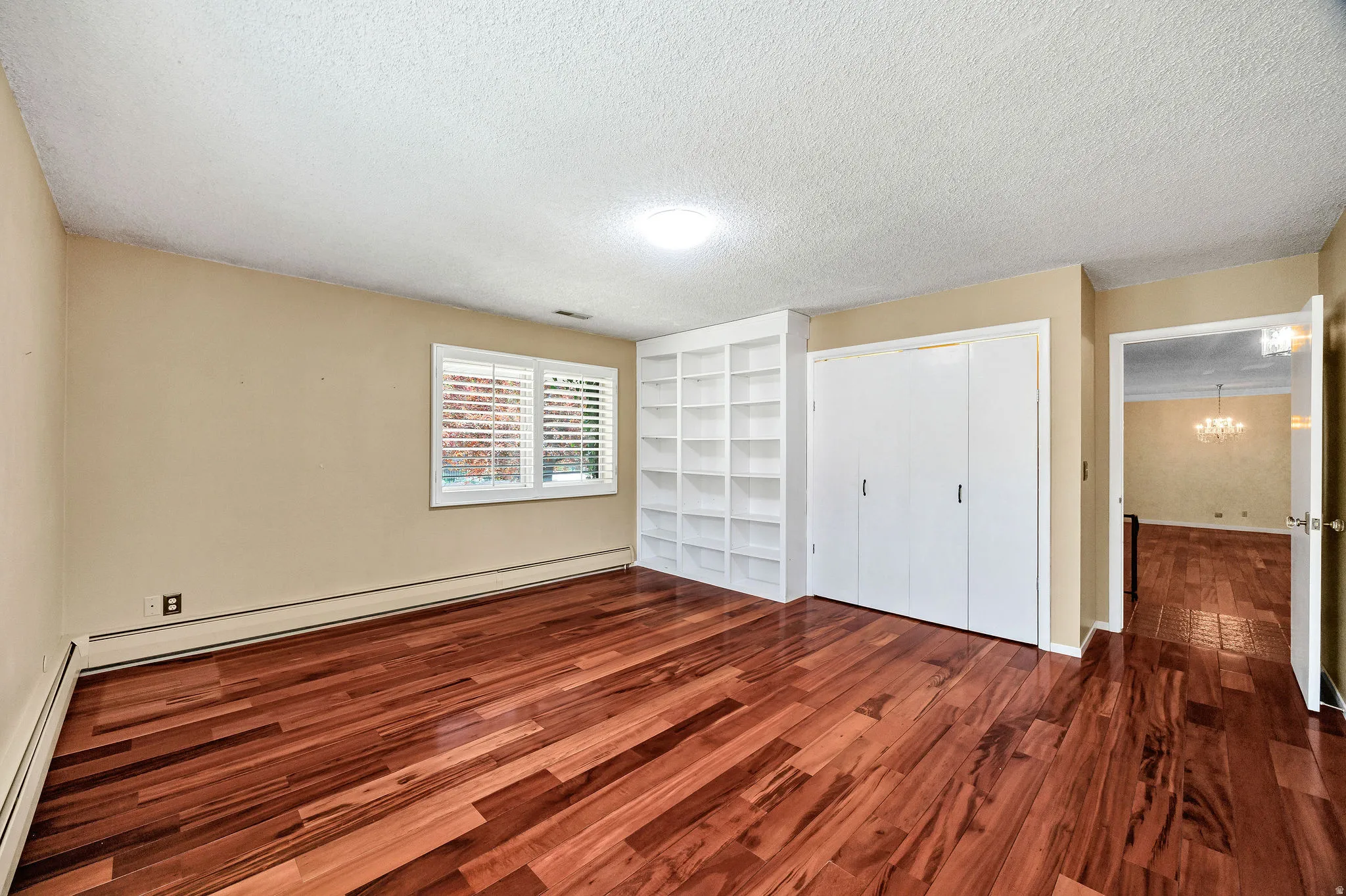 Rich wood-finish flooring complements the neutral wall tones