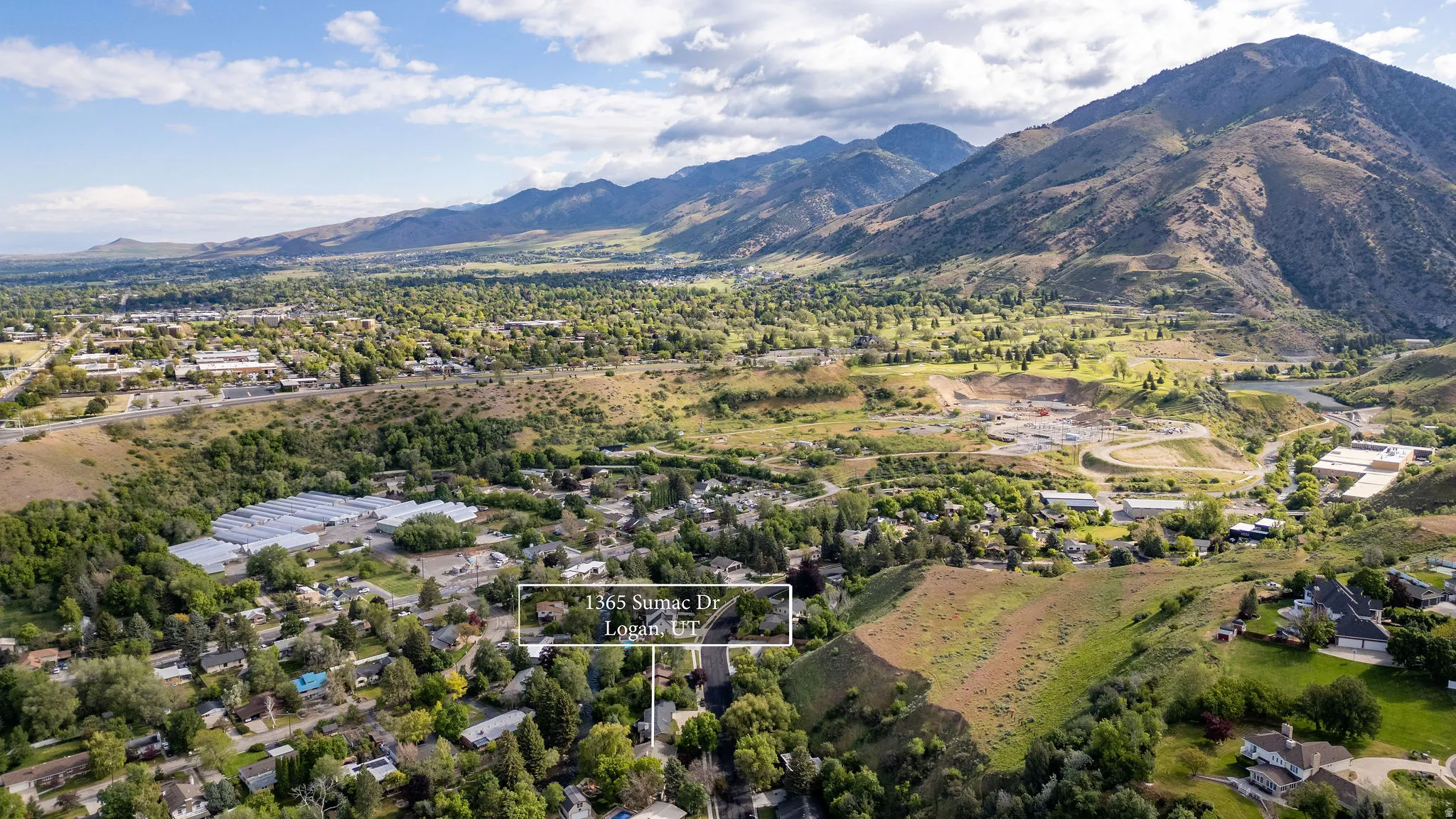 Expansive aerial perspective showcasing the property within a mountainous landscape