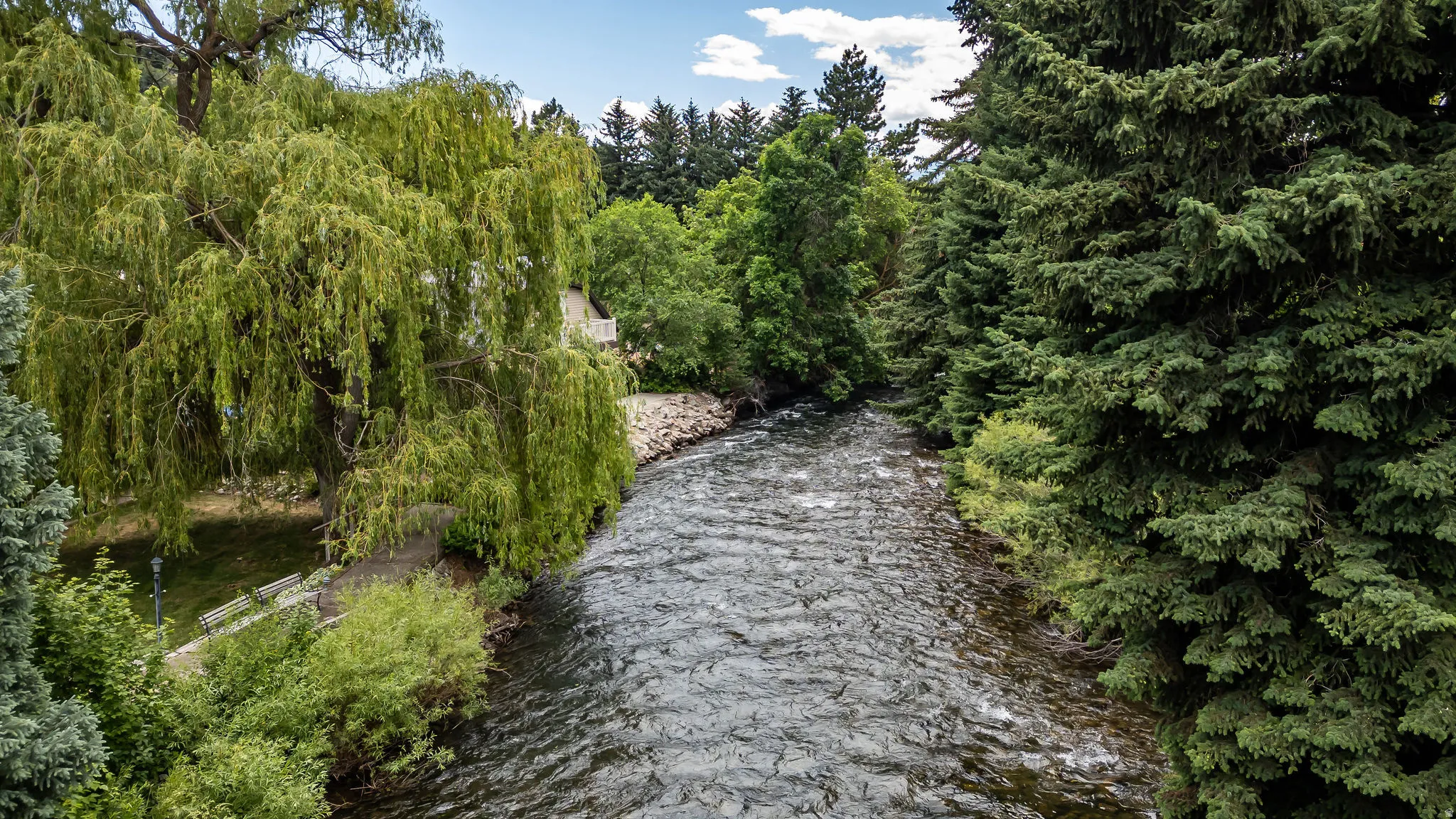 Riverfront setting featuring a flowing waterway