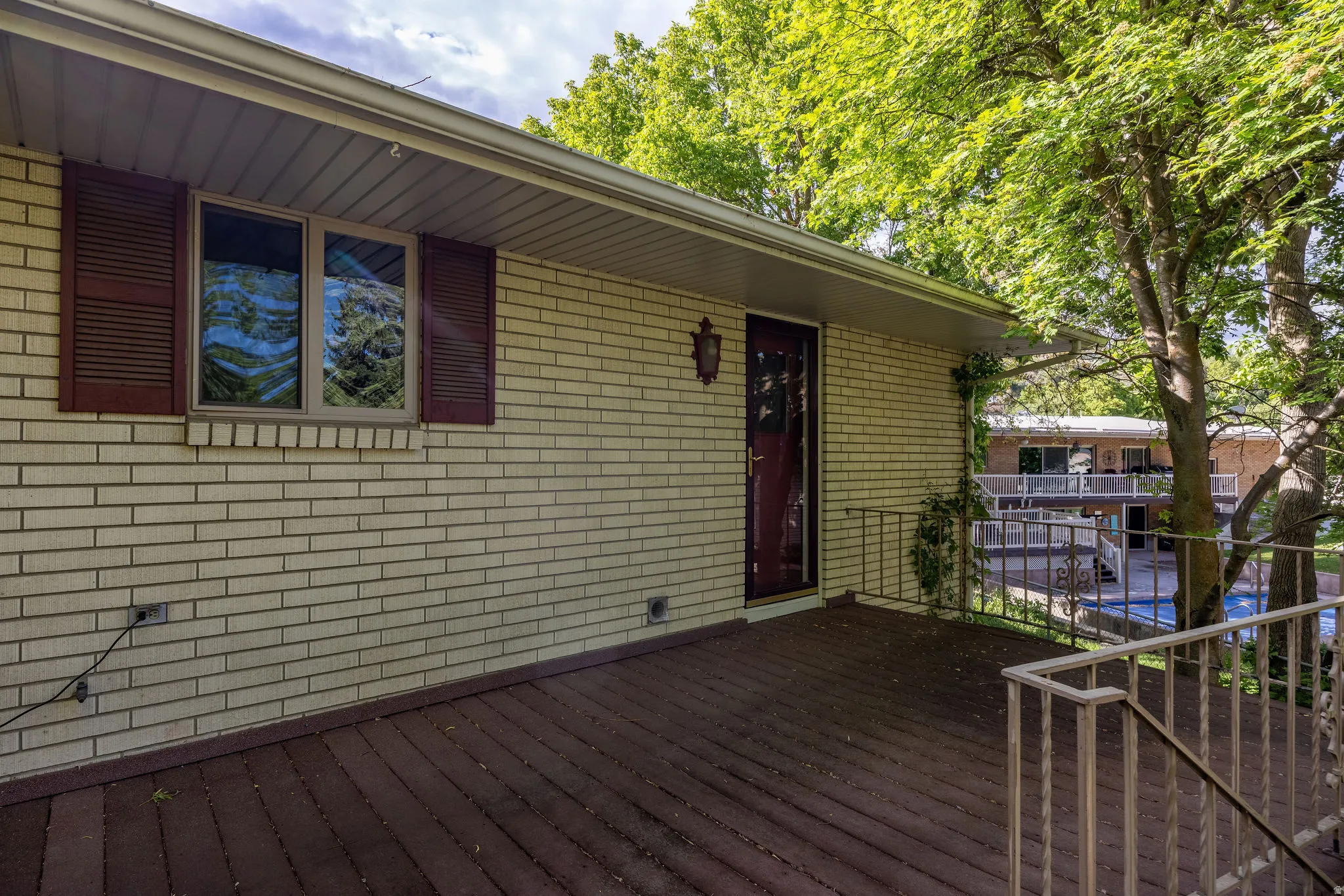 Spacious outdoor deck featuring wood-finish flooring and metal railings
