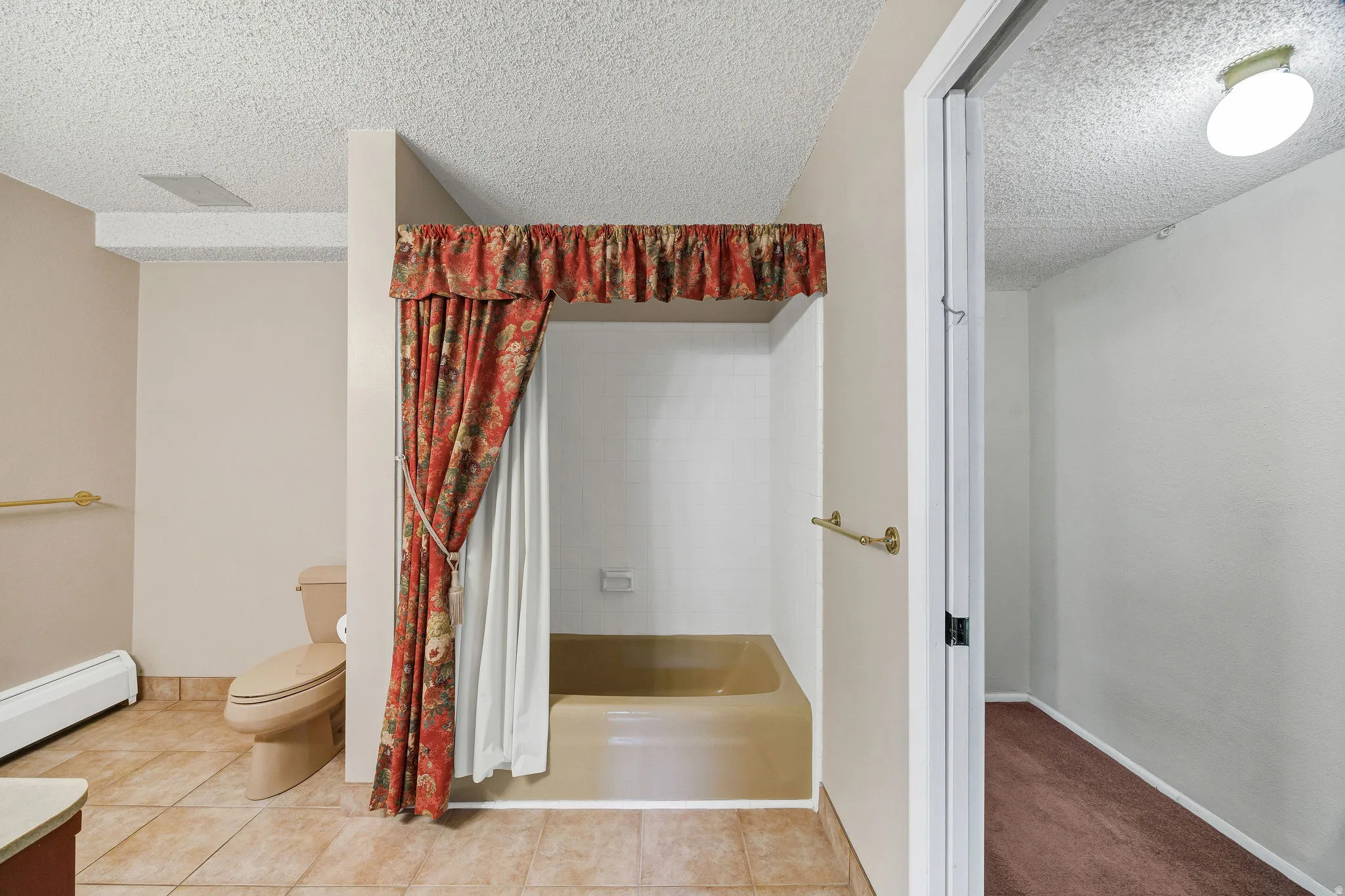 Bathroom featuring a built-in tub, tiled flooring, and a flush-mount ceiling light