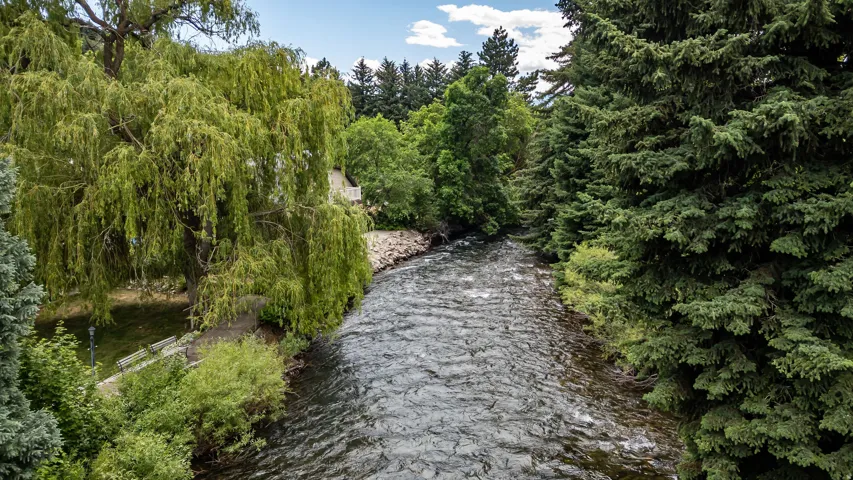 Riverfront setting featuring a flowing waterway