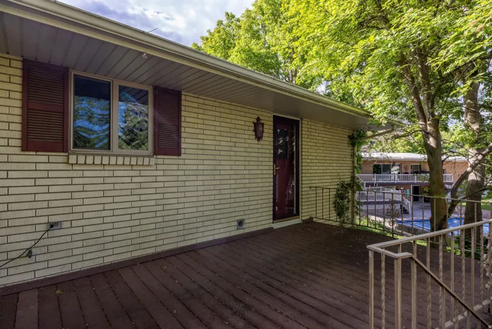 Spacious outdoor deck featuring wood-finish flooring and metal railings