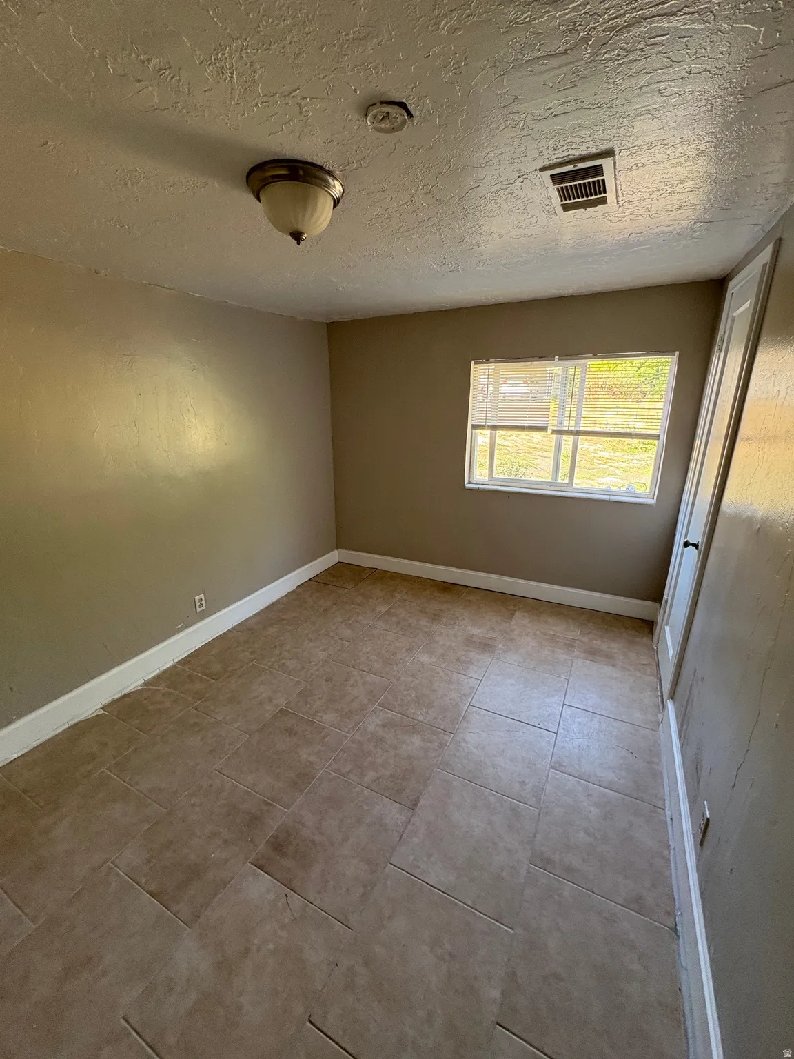 Room featuring light neutral wall paint and a single window