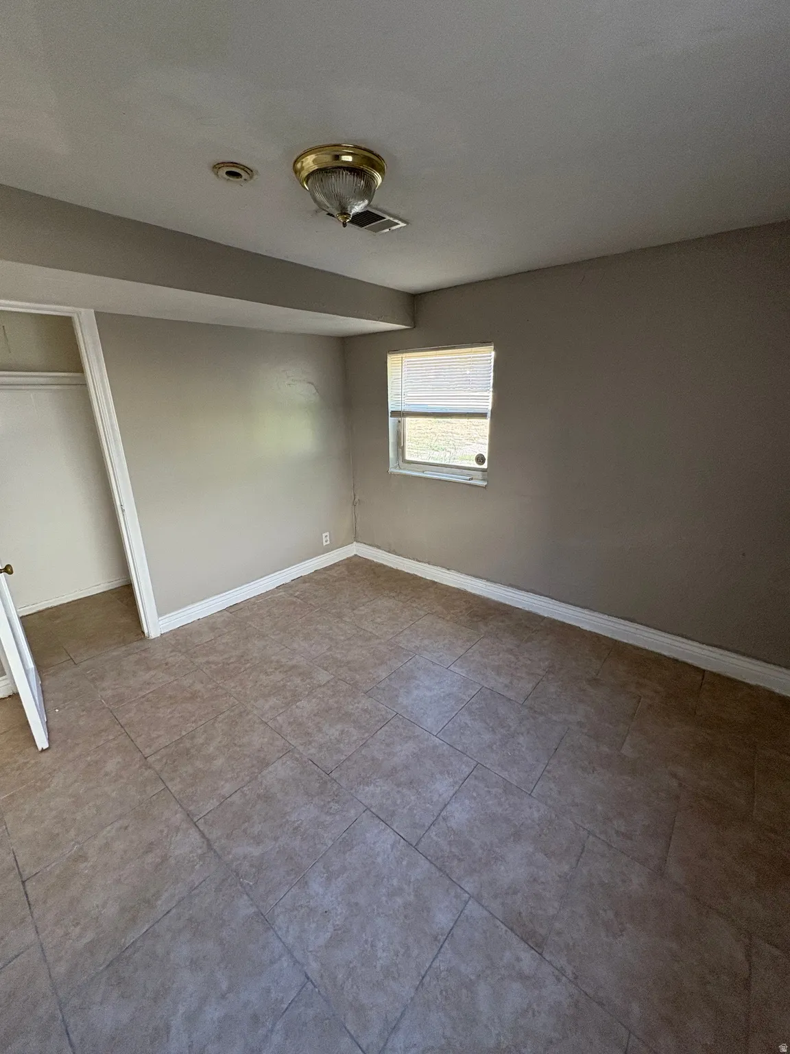 Room featuring tile flooring and neutral wall tones