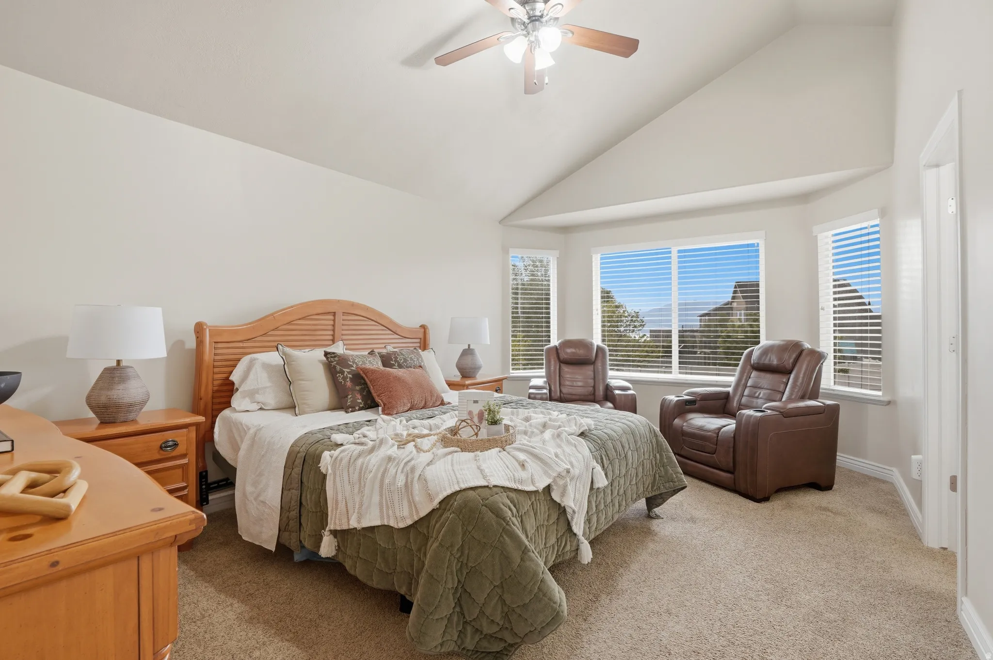 Primary bedroom with its own on-suite featuring vaulted ceilings and a bay window