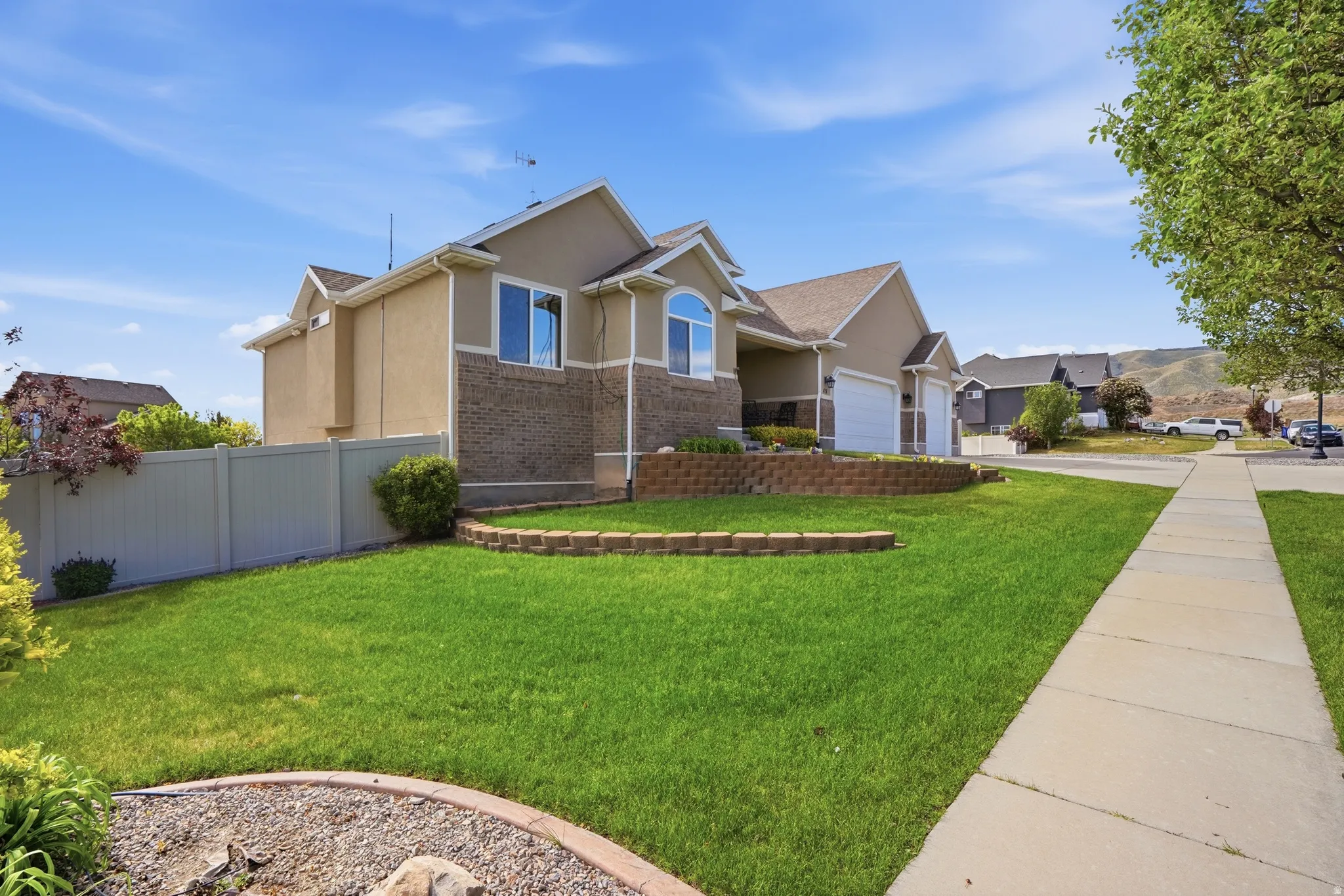Two-story residence featuring a combination of stucco and brick siding