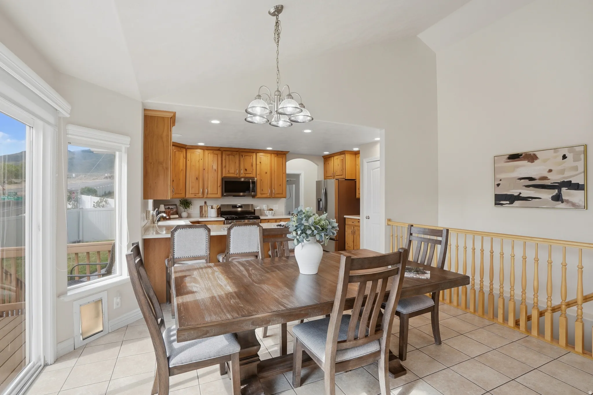 Dining area with tile flooring and vaulted ceiling