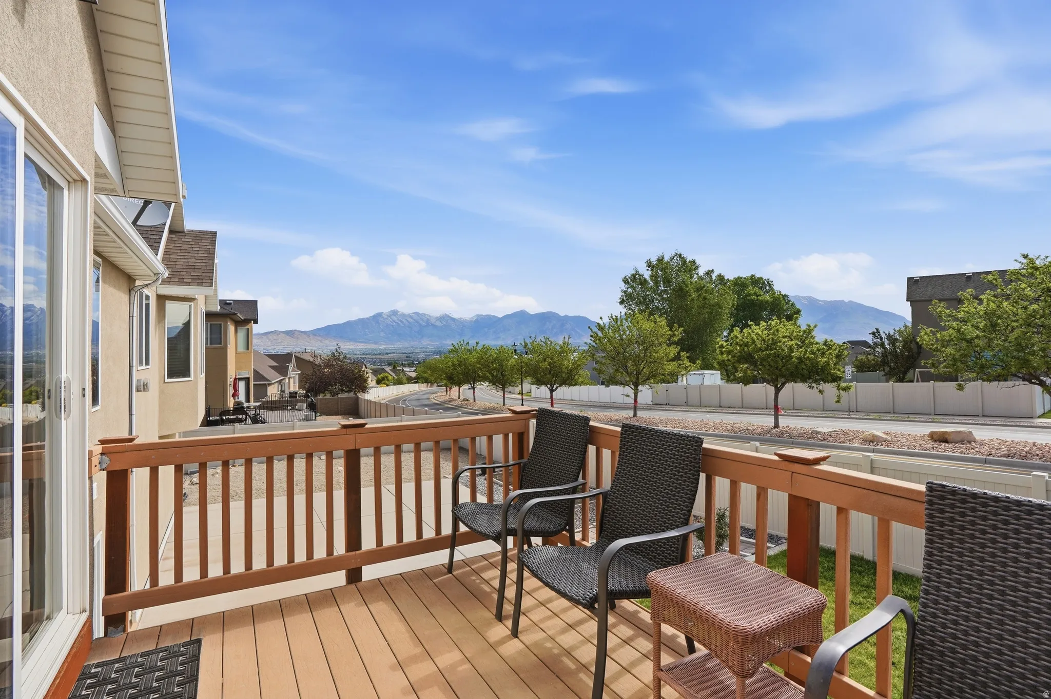 Spacious outdoor deck with wood-finish railing and composite decking, offering expansive mountain scenery