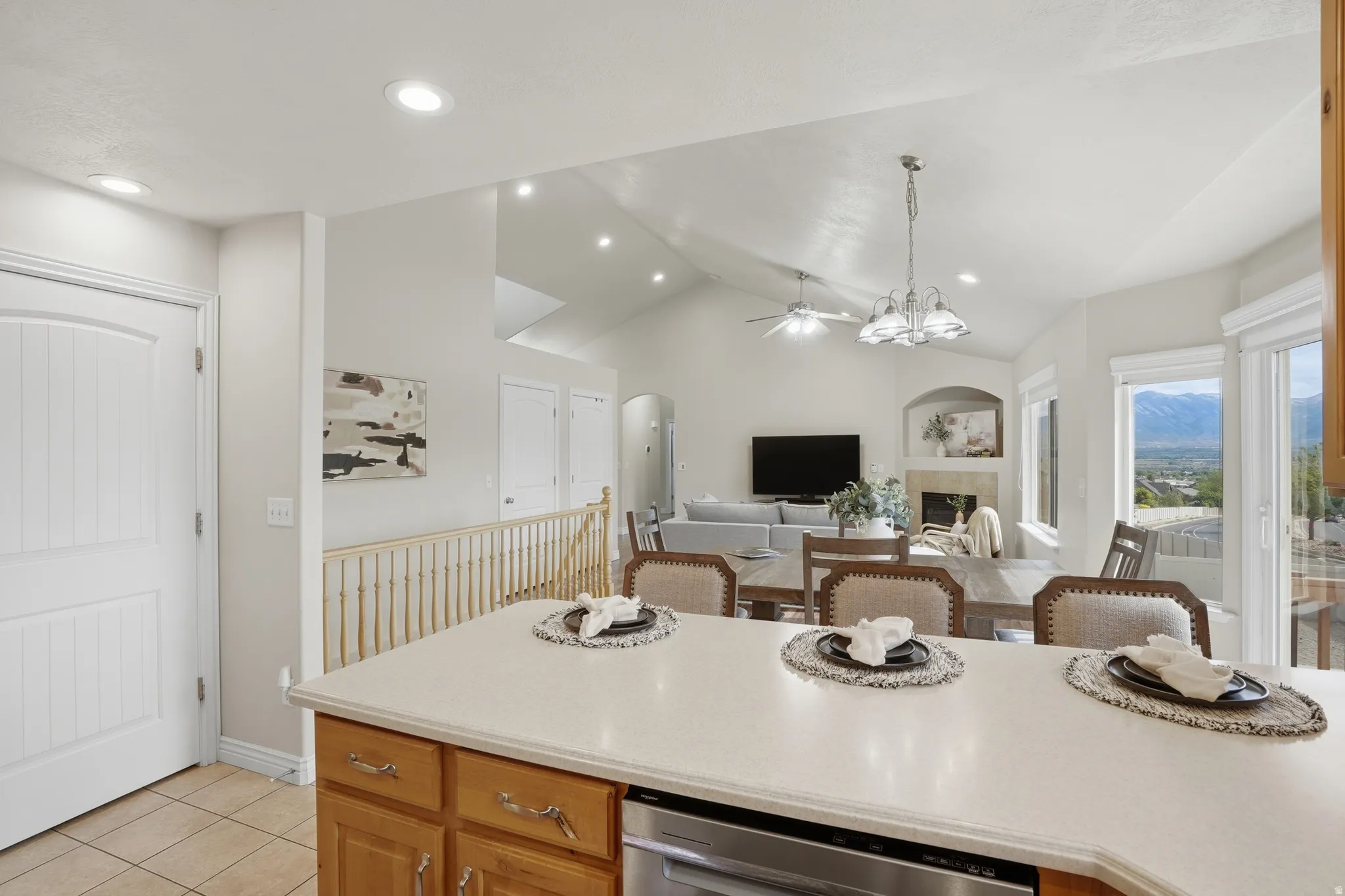 Kitchen island with a light-toned countertop, wood-finish cabinetry, and an integrated stainless steel appliance