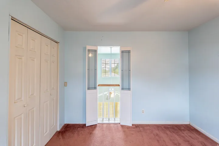 Soft blue painted walls with carpeted flooring