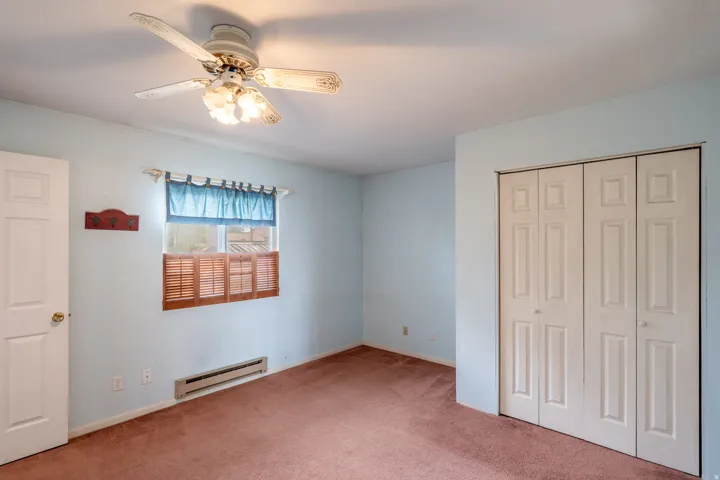 Interior room featuring light blue walls and brown carpet flooring