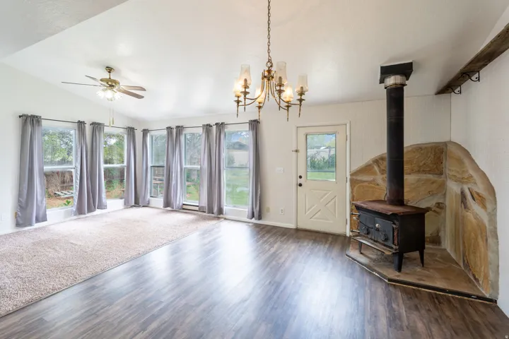 Interior space featuring wood-finish flooring, a vaulted ceiling, and an exposed wood beam
