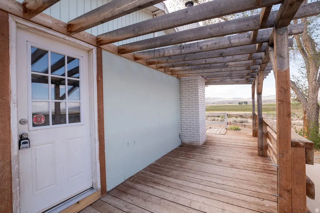 Expansive outdoor deck featuring weathered wood planks and a coordinating wood pergola structure