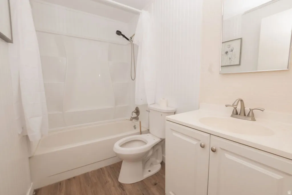 Bathroom featuring a white vanity with integrated sink, brushed nickel faucet, and a large wall-mounted mirror