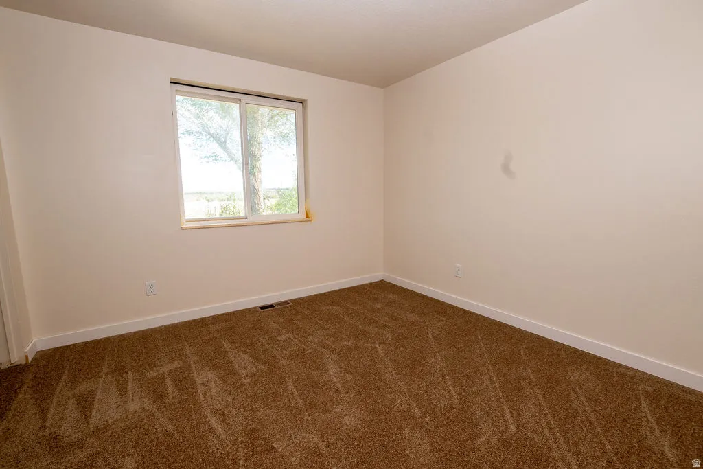 Neutral-toned walls and brown carpet create a versatile interior