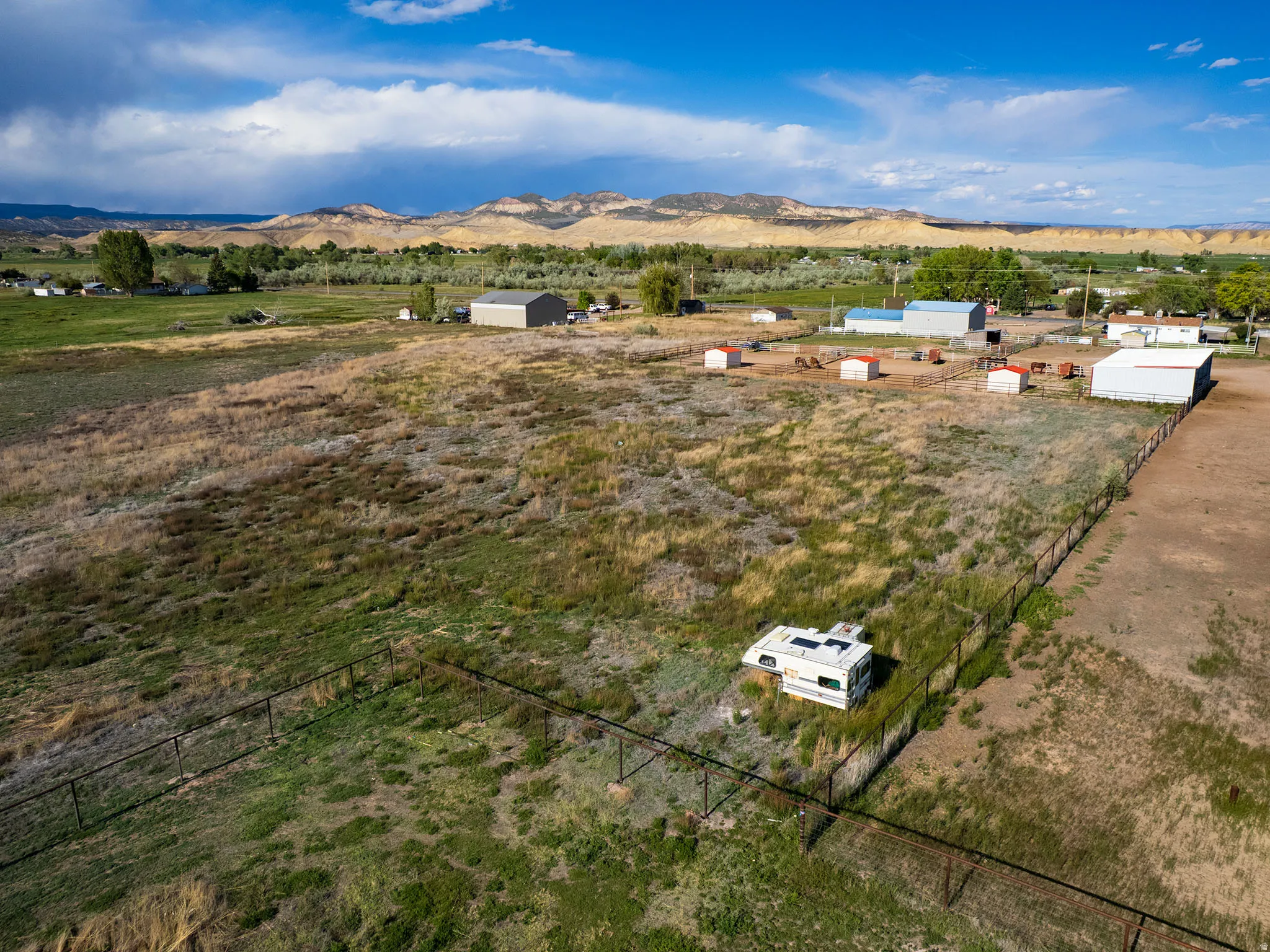 Expansive land parcel featuring open fields and distant mountain scenery